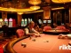 Engaged players at a rikbet poker table in a luxurious casino environment.