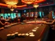 Experience the excitement of rr888 at a luxurious baccarat table in a high-end casino setting.