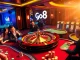 Experience the thrill of the go8 casino with vibrant roulette wheels and excited players.